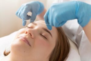 Brow Bar Professional eyebrow threading service in progress